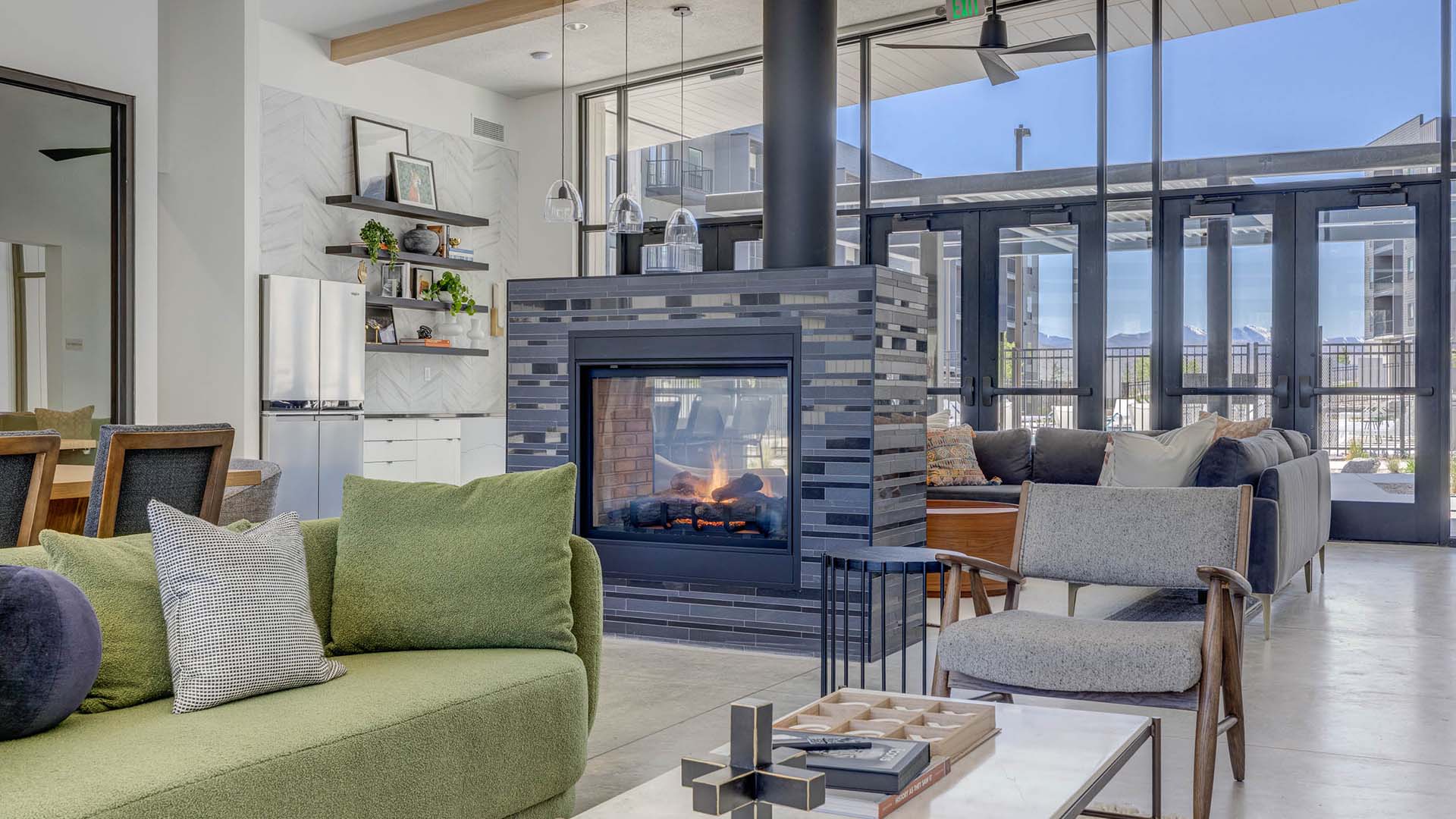 Terra Vista apartments lounge with plush seating, fireplace, and community kitchen.