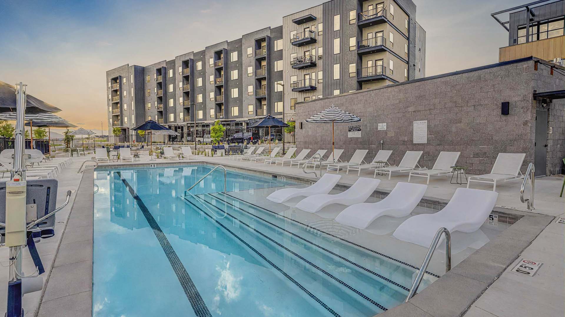 Terra Vista apartments pool area with lounge chairs and umbrellas.